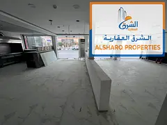 Shop for annual rent in Al-Rashidiya 1, next to Ramada Park Hotel, available in a prime location wit