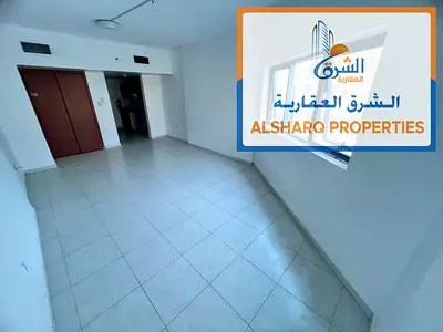 Studio in Falcon Towers, Al Rashidiya 2, spacious, built-in wardrobes, central AC, open view, free maintenance, prime location.