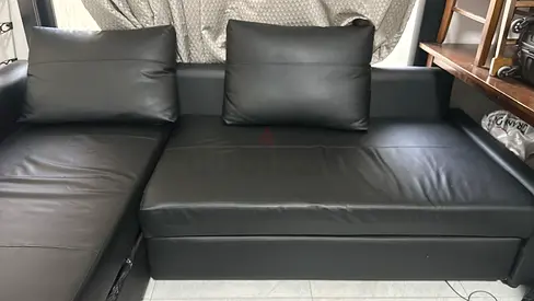 Black leather L-shaped corner sofa bed - good condition