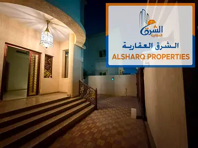 Corner villa in Al Rawda 3 Ajman, 5 master bedrooms, maid room, majlis, living room, 2 kitchens, roof, central AC, spacious for families.