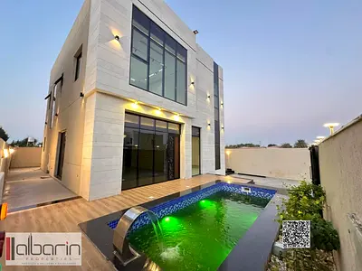 White stone villa for sale in Al Zahia, with private pool and central air conditioning.
