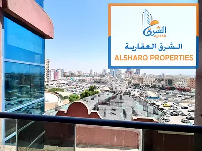 Studio apartment with balcony for annual rent, American-style kitchen, private parking, central air conditioning, suitable for families, maintenance i