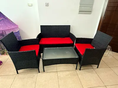 4-piece rattan patio seating set with red cushions (sofa, 2 chairs, coffee table)