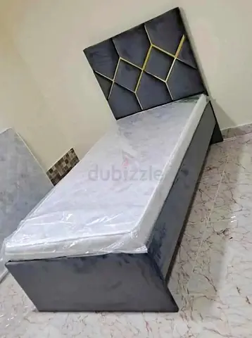 Single upholstered bed with padded geometric headboard - grey