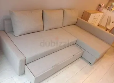 Light beige L-shaped sofa with pull-out bed — good condition