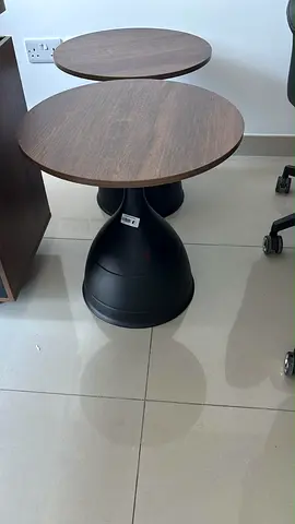 Pair of modern round side tables with wood tops and black bases
