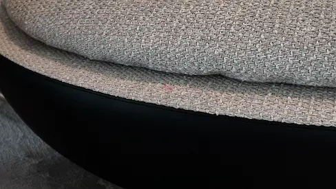 Light grey upholstered swivel lounge chair with black base - good condition