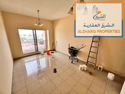 Spacious studio for annual rent in Al Nuaimiya 1, Ajman, near Day to Day, featuring a fully separate kitchen, balcony with open view, and central AC.