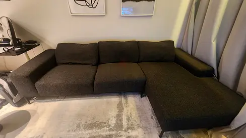 Dark grey L-shaped 3-seater sectional sofa with chaise