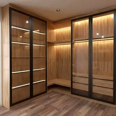 Custom built-in wooden walk-in wardrobe with glass doors and LED lighting