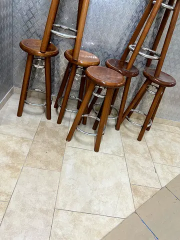Set of 12 wooden bar stools with metal footrests - good condition