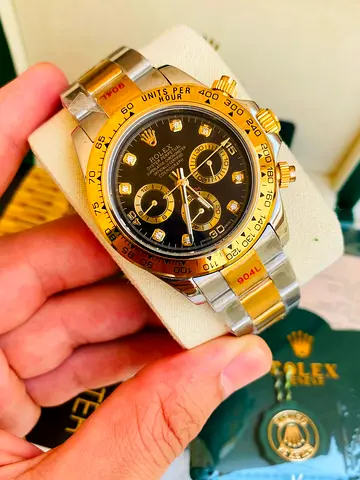 The featured timepiece is a Rolex Cosmograph Automatic watch 41 mm Daytona two-tone in yellow gold a
