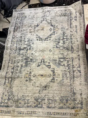 Used neutral grey vintage-style area rug - 5x8 (approx.)