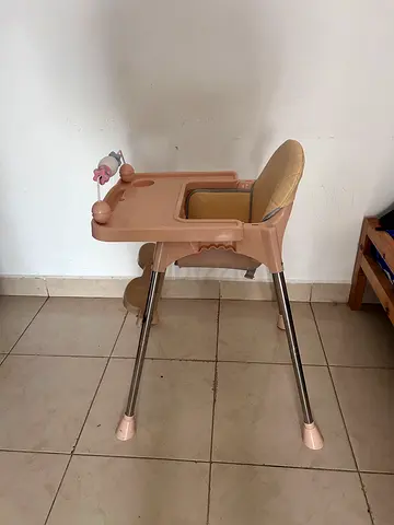 Used beige plastic baby high chair with tray