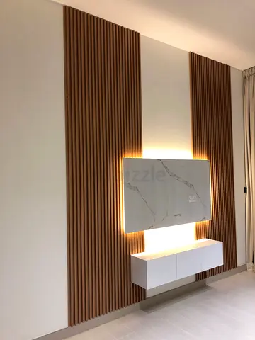 Modern wall-mounted TV panel with vertical wood slats and LED backlight