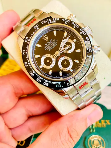 The Rolex Cosmograph automatic watch 41mm Daytona features a black dial with a black tachymetric cer