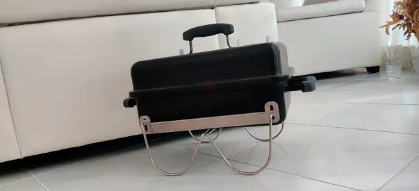 Weber portable charcoal BBQ grill with folding legs — barely used