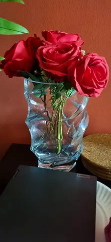 Glass decorative vase with artificial red roses