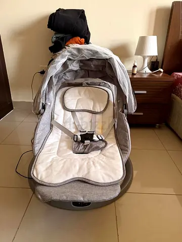 Light grey baby rocker/swing with harness and canopy and remote - gently used