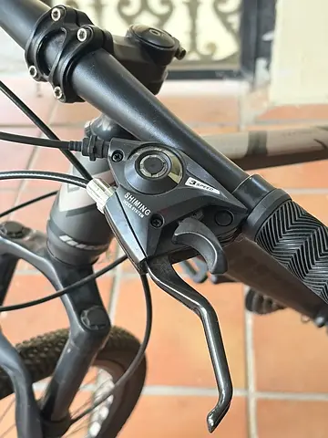 Used hybrid/mountain bike - Shimano trigger shifters and front brake (wheel shown)
