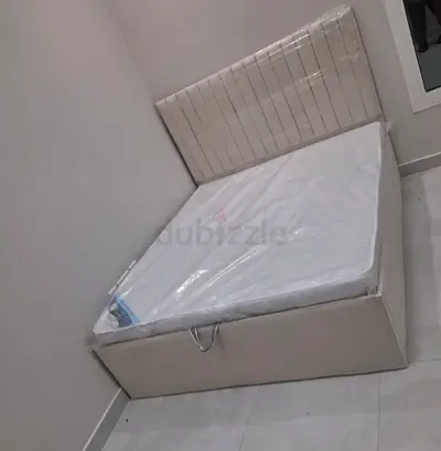 Beige upholstered double bed with mattress (like new)