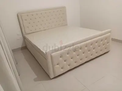 Cream tufted king-size bed frame with mattress included