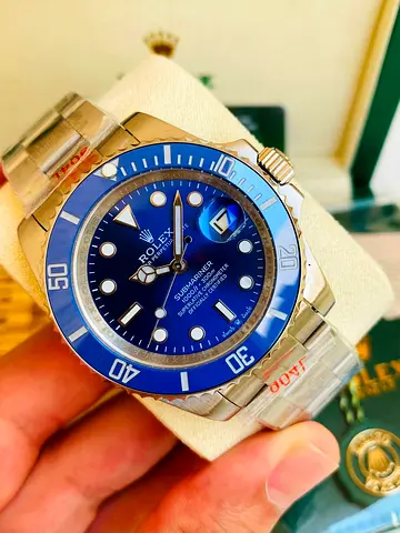 This image features the iconic Rolex Submariner Date "Smurf" automatic watch 41m mcrafted in 18k whi