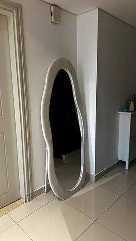 Full-length freestanding oval floor mirror with silver frame