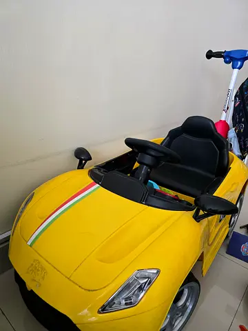 Yellow electric ride-on car for kids with working steering and seatbelt