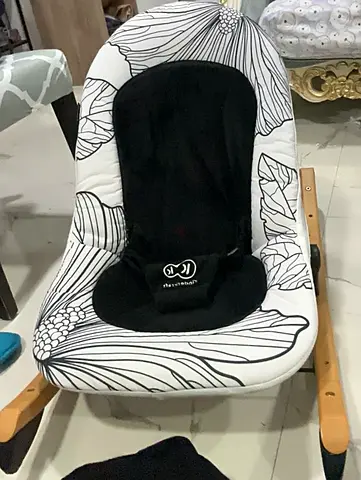 Baby bouncer / rocker with floral cover — good condition