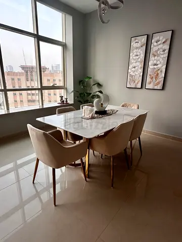 Modern marble-top dining table with 6 beige chairs