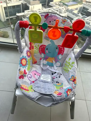 Used colorful baby bouncer/rocker with toy bar - used only for 1 month- use less than 1 year