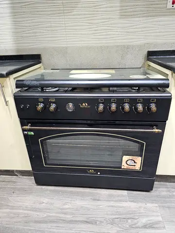 Used black freestanding gas oven with stovetop — good working condition