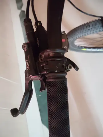 Used mountain bike handlebar with shifter and brake lever