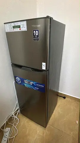 Compact double-door refrigerator - good condition, 10-year warranty label