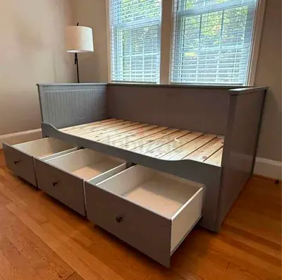 Gray wooden daybed with three under-bed storage drawers