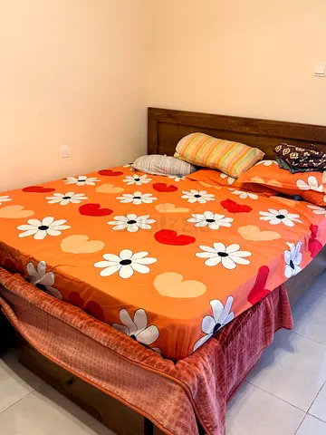 Wooden double bed frame with mattress and bedding - good condition