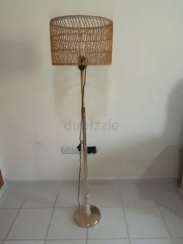Rattan-style floor lamp with woven shade - good condition