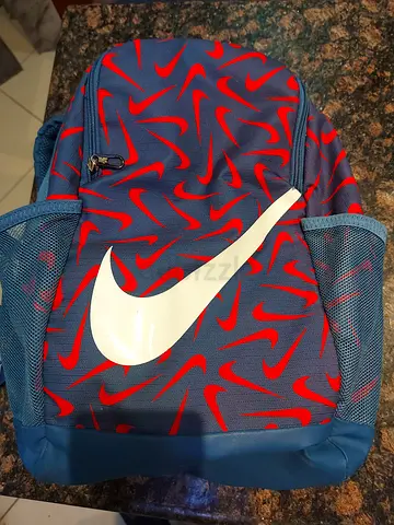 Nike backpack with bold swoosh — blue/red casual daypack