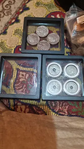 Collection of vintage coins in display cases