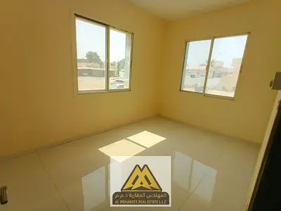 2 bedrooms and a living room, 2 bathrooms, closed kitchen, split AC, ground floor, close to all services, AED 33,000, 4 installments.