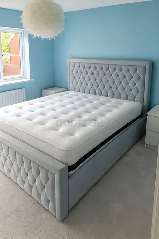 Light grey upholstered king size bed frame with storage