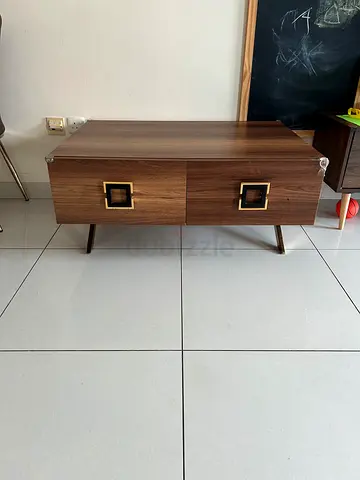 Small wooden two-drawer coffee table in walnut finish
