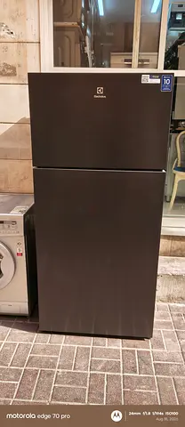 Black top-freezer refrigerator in good working condition