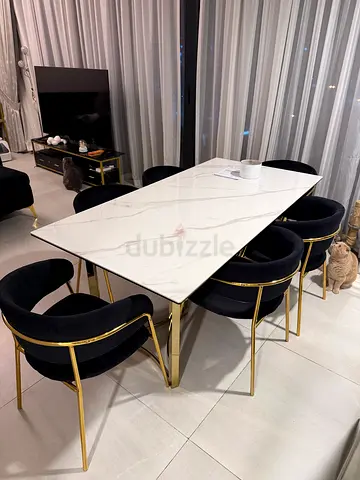 Modern marble-top dining table with 6 black velvet chairs (gold frame)