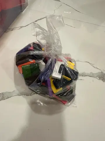Bag of multicolour plastic geometric toy pieces - bricks