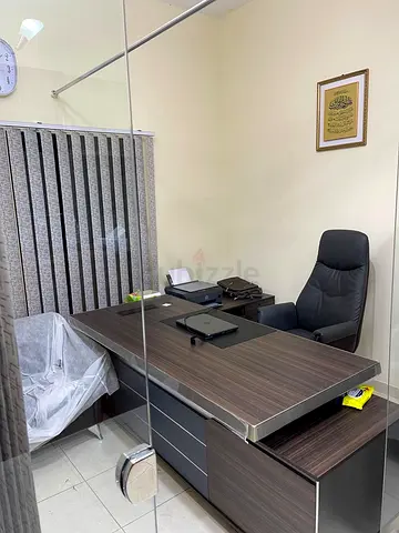 A complete office with a sofa and two chairs