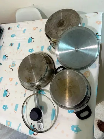 Set of used stainless steel pots and pans with lids - 5 pieces