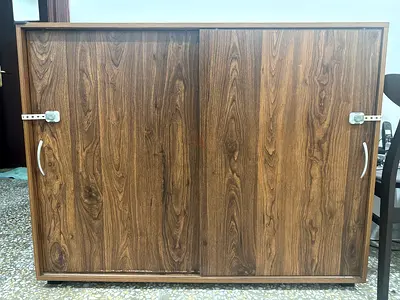 Low wooden storage cabinet with sliding doors