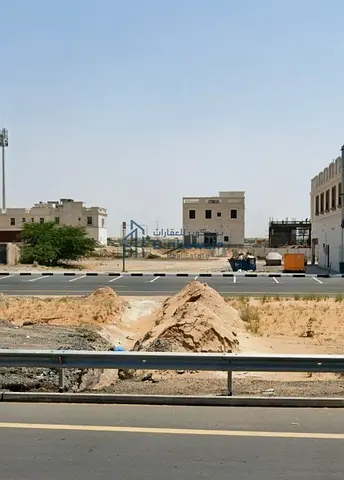 For sale: a residential and commercial plot in Al Malhah, directly on Al Dhaid Road